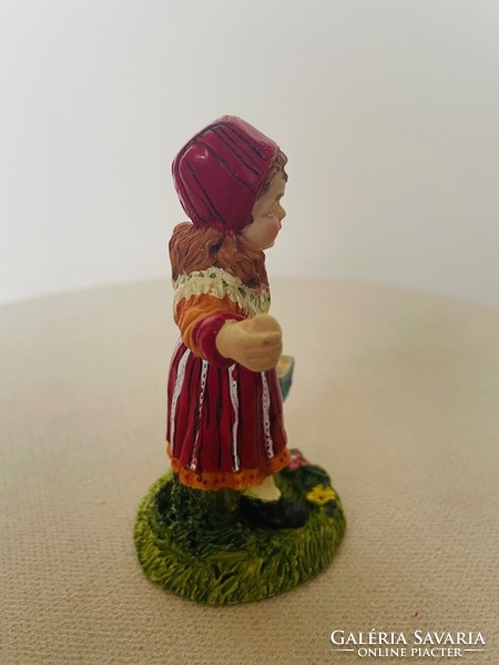 Ceramic figural sculpture: a little girl in a red headscarf with a basket of eggs