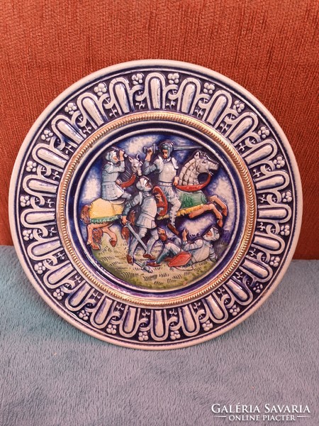 Painted-glazed ceramic wall plate, with a plastic battle scene, marked 'gerz germany'.