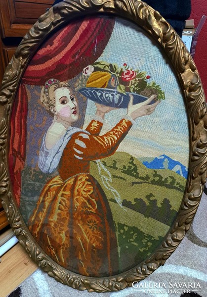 In a giant oval frame, tapestry