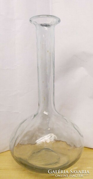 A wine bottle blown into an antique shape, a finely crafted piece with a rustic side