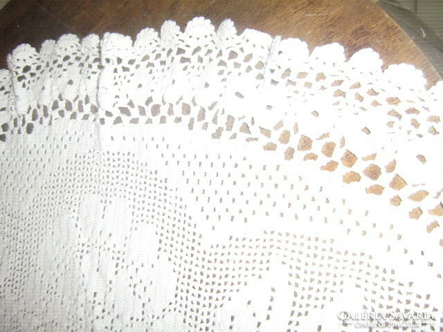 Beautiful handmade crochet on a pale light blue tablecloth