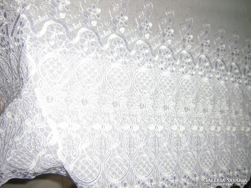 A curtain with flower embroidery in a fairy-tale white material