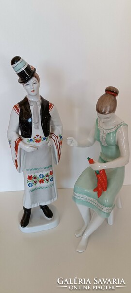 A porcelain boy in Hollóháza folk costume and a girl with a bell pepper