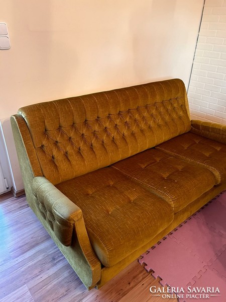 A sofa that can be converted into a bed and 2 armchairs are deep-stitched in antique gold.