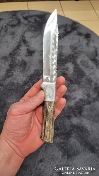 Old hunting dagger with saw.