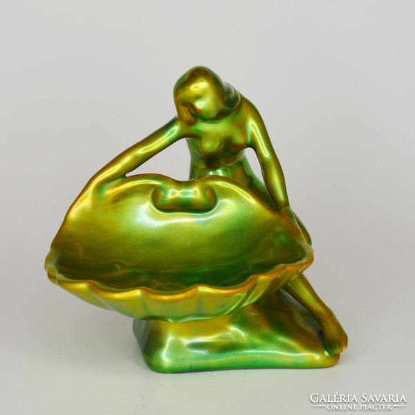 Zsolnay is a woman holding an eosin-glazed shell