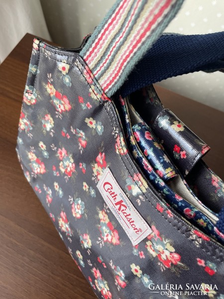 Cath kidston wonderful small floral oil clothes handbag on a blue background