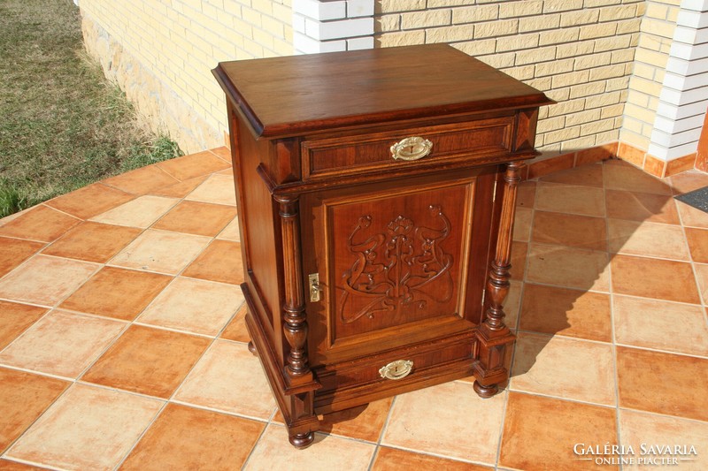 A tin German, richly carved chest of drawers