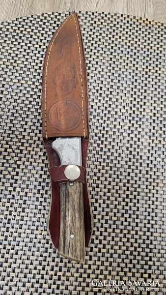 Old hunting dagger with saw.