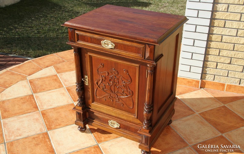 A tin German, richly carved chest of drawers