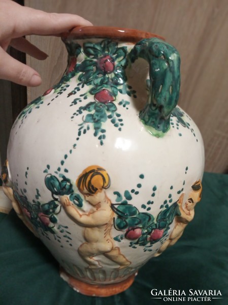 Old jug decorated with putts