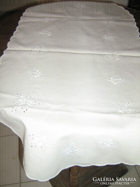 Beautiful hand embroidered runner with slinged edge on elegant beige tablecloth
