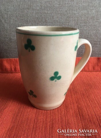 Old granite mug with green leaf motif