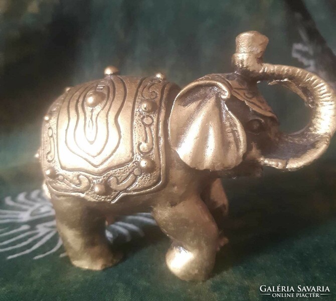 Golden elephant statue with an upturned trunk