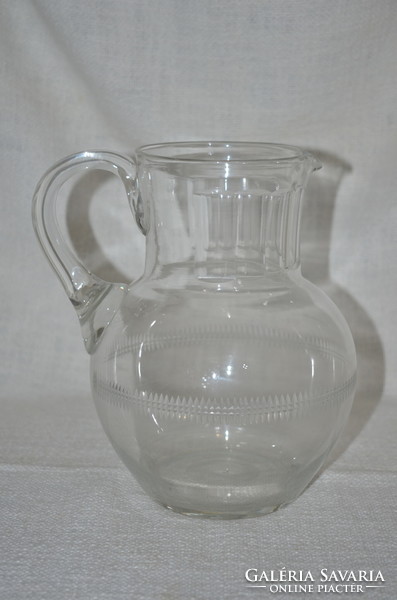 Broken glass jug with polished decoration