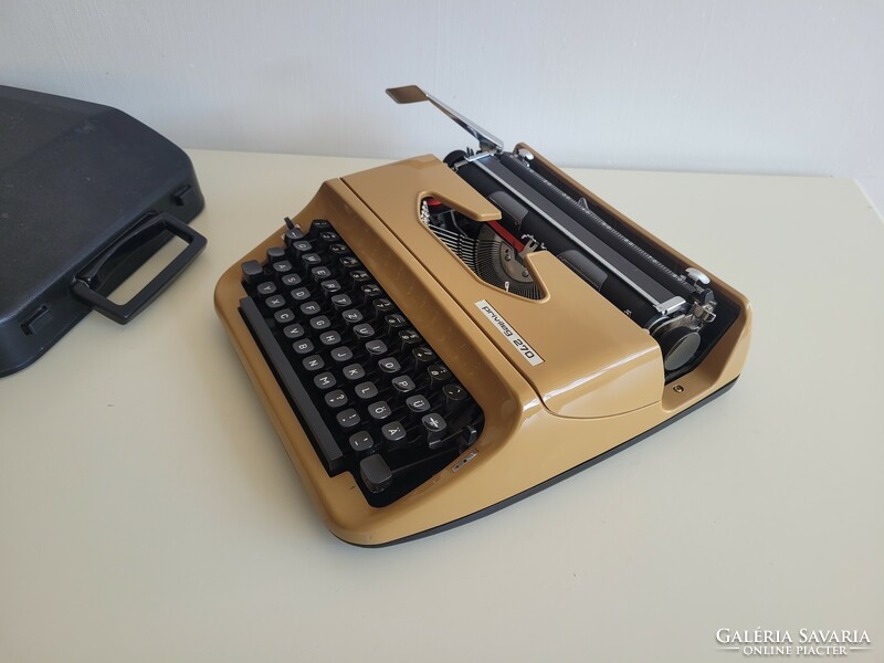 Old retro small pocket typewriter mid century typewriter in caramel color