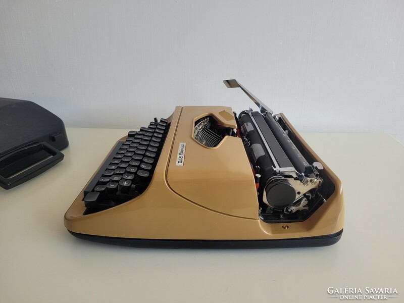 Old retro small pocket typewriter mid century typewriter in caramel color