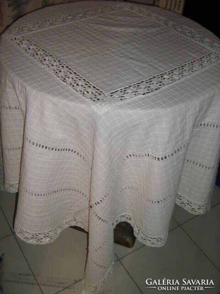 Beautiful azure decorated table cloth with small wooden balls in the middle and lace on the edge