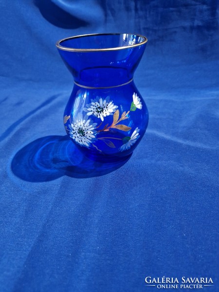 Blue glass vase decorated with white flowers and gold