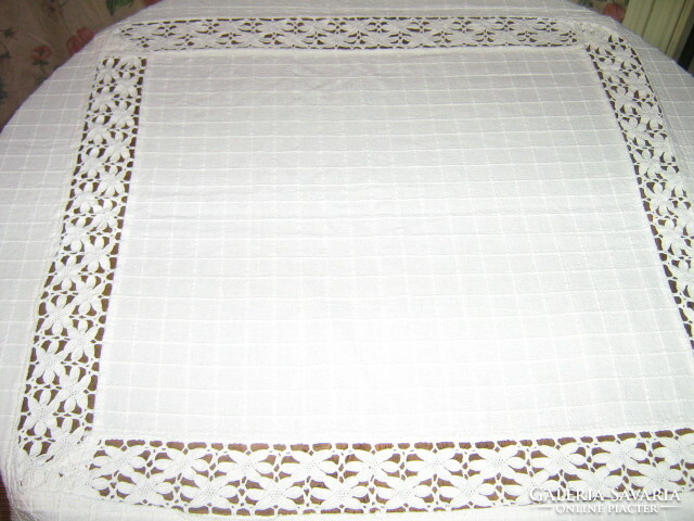 Beautiful azure decorated table cloth with small wooden balls in the middle and lace on the edge