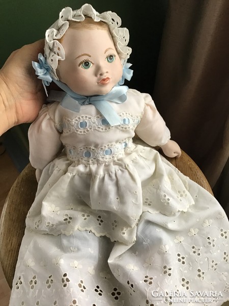 Hand-painted artist doll with porcelain head and porcelain limbs in Madeira patterned dress