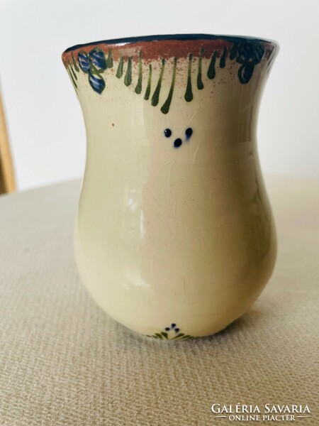 Bright glazed ceramic small vase with a folk motif