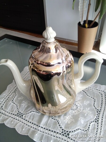 Large porcelain warming tea and coffee pot covered with a chrome-plated thermo jacket.