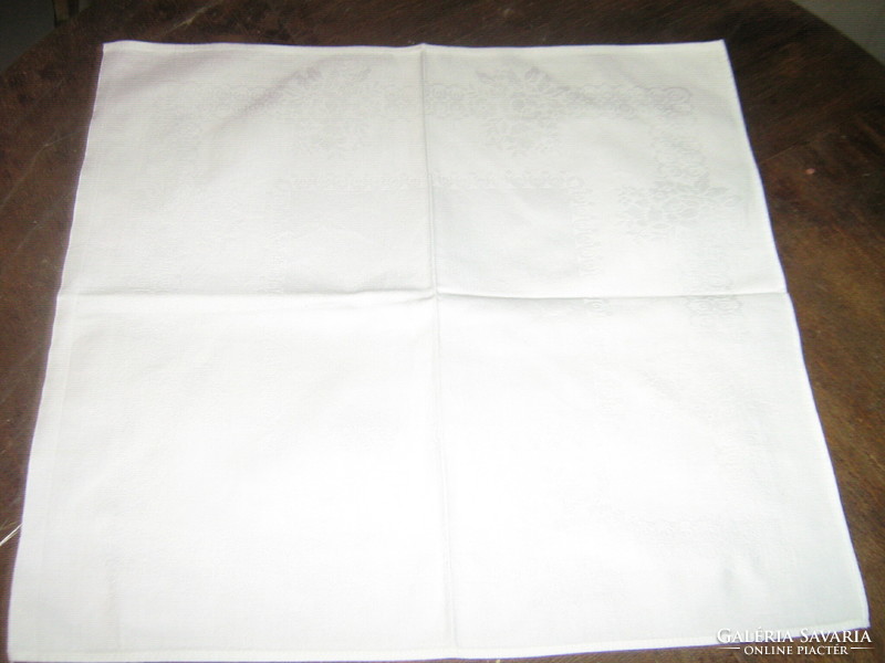 White damask napkin with a beautiful flower pattern
