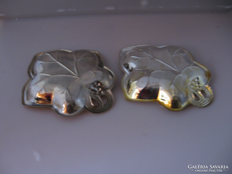 Silver-plated grape leaf-shaped bowl offering nuts, chocolates and candies in a pair