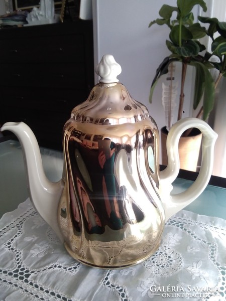 Large porcelain warming tea and coffee pot covered with a chrome-plated thermo jacket.