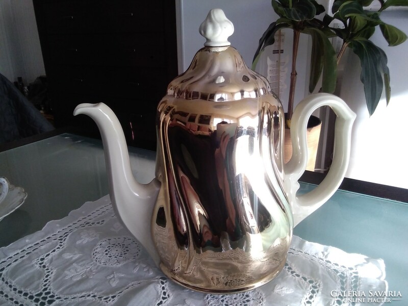 Large porcelain warming tea and coffee pot covered with a chrome-plated thermo jacket.