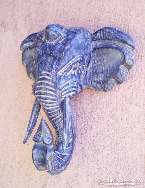 Painted elephant head carved wood sculpture from Indonesia. Decoration that can be hung on the wall