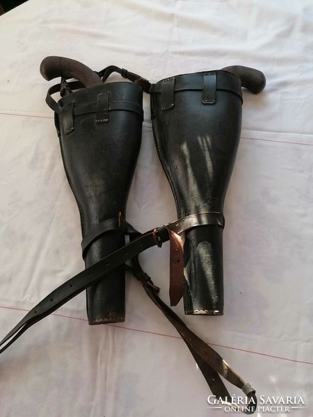Antique leather saddlebags with wooden rifles