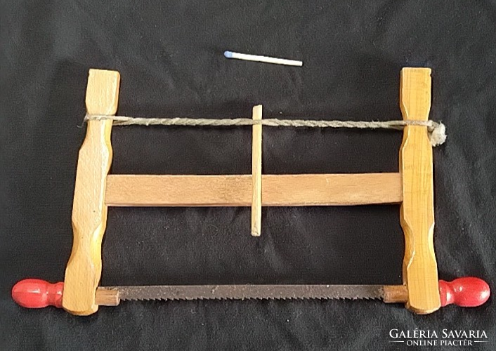 Retro toy saw - old carpenter's hand saw with a wooden frame