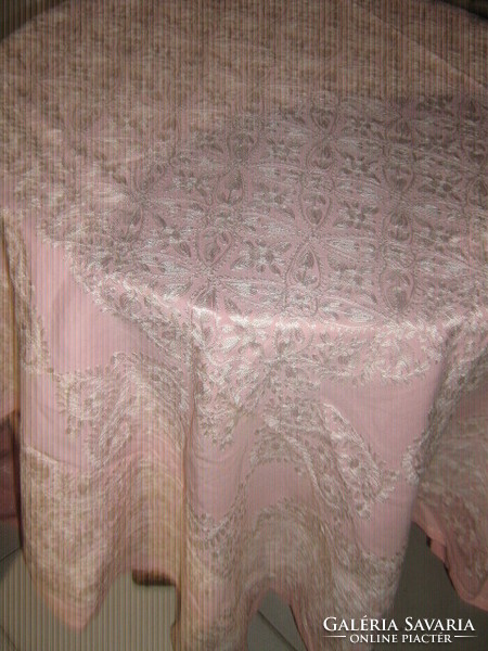 Pink elegant tablecloth richly embroidered with white fabric