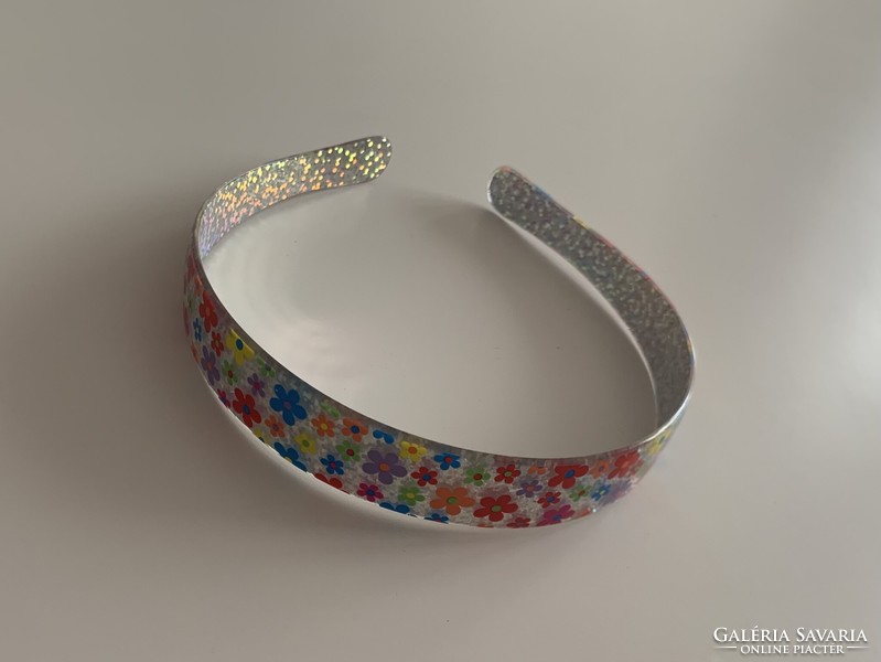 A special floral headband scatters the light like a prism
