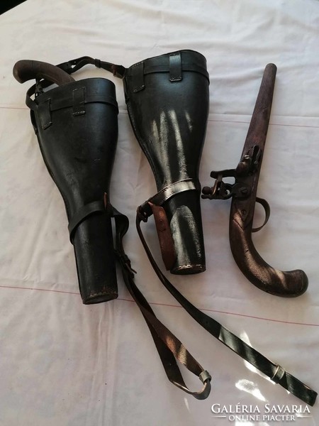 Antique leather saddlebags with wooden rifles