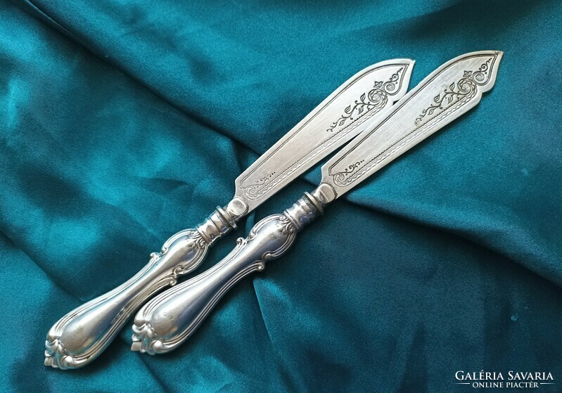 A silver-plated knife with a decorative blade