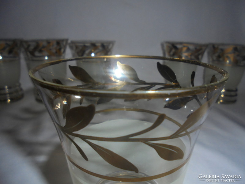 Six pieces of old glass goblets with a richly gilded leaf design