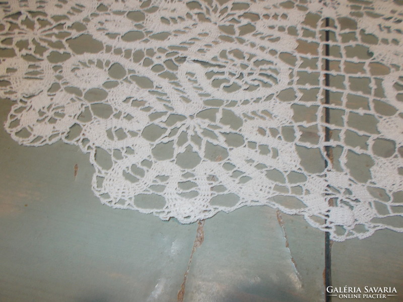 Beautiful runner with ribbon crocheted in the pattern of beaten lace