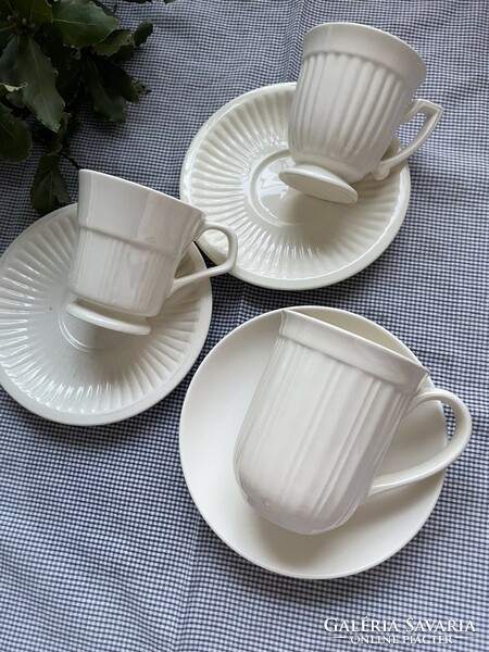 Cream-colored small mug with a wonderful rim design, empire ribbed walls, clean lines