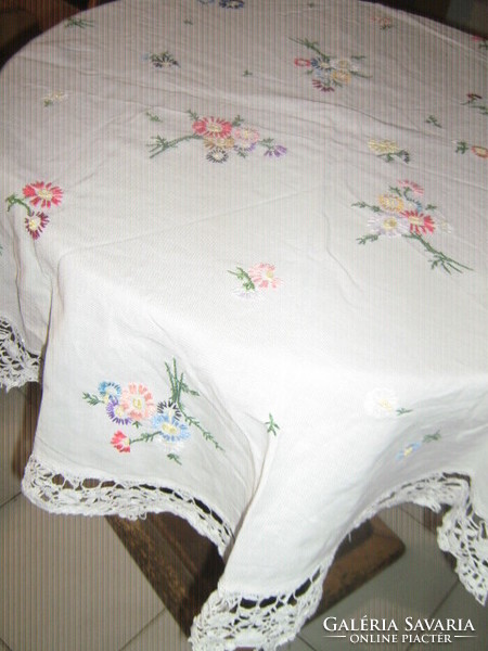 Beautiful hand-embroidered round tablecloth with a lace edge