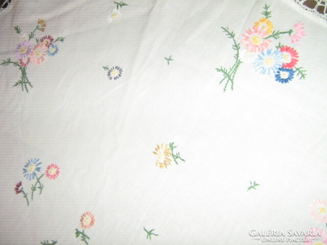 Beautiful hand-embroidered round tablecloth with a lace edge
