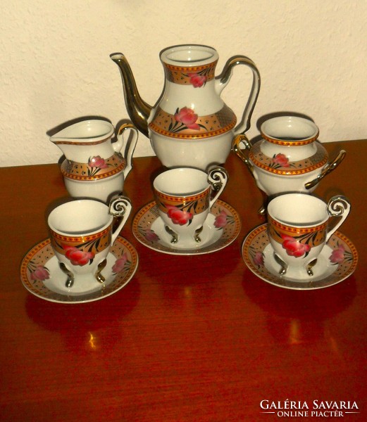 Richly gilded Chinese porcelain standing on graceful legs, 9-piece coffee and tea set.