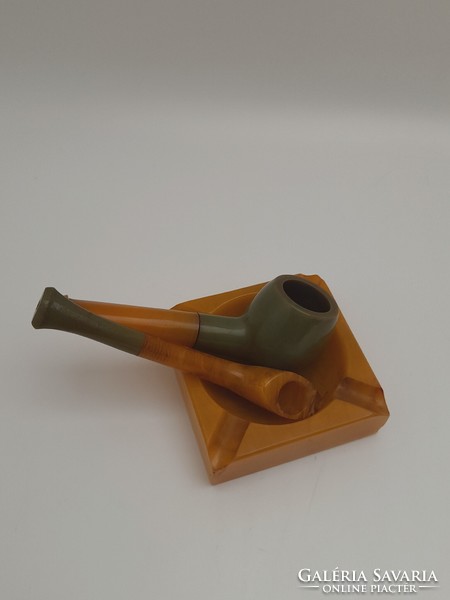 A small vinyl ashtray and two small pipes, 3 in one