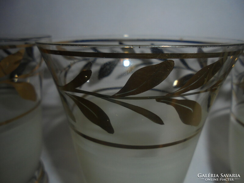 Six pieces of old glass goblets with a richly gilded leaf design