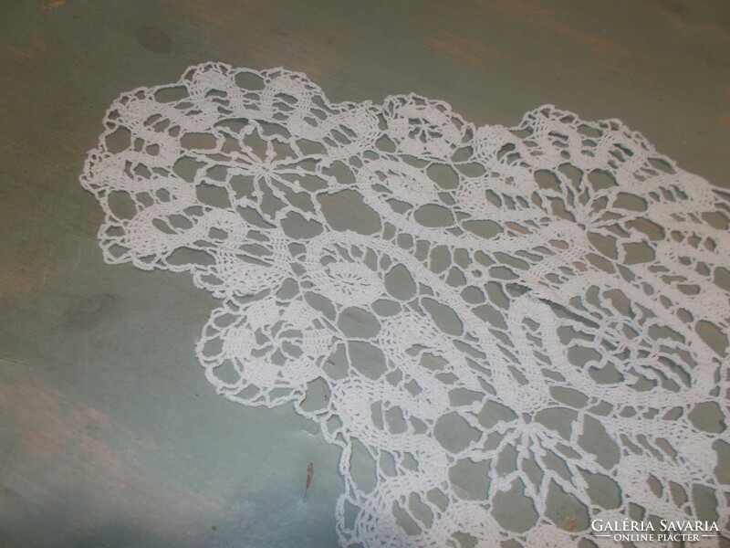 Beautiful runner with ribbon crocheted in the pattern of beaten lace