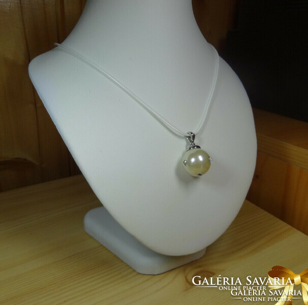 A very beautiful pendant made of shell pearls, decorated with 4 cubic zirconia stones + white chain.