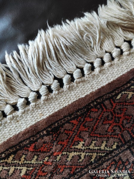 A small rug with a fringed Persian pattern from the legacy of the photographer 