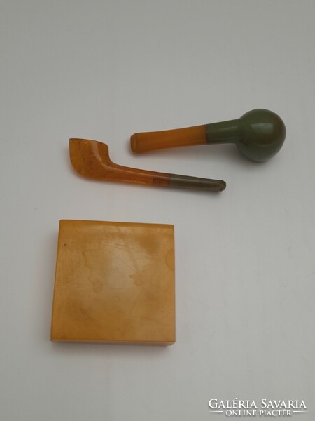 A small vinyl ashtray and two small pipes, 3 in one
